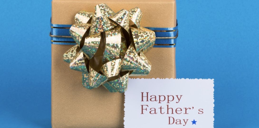 A wrapped gift next to a Happy Father's Day sign