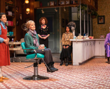 five female actors on a stage in a play the location is a hair salon