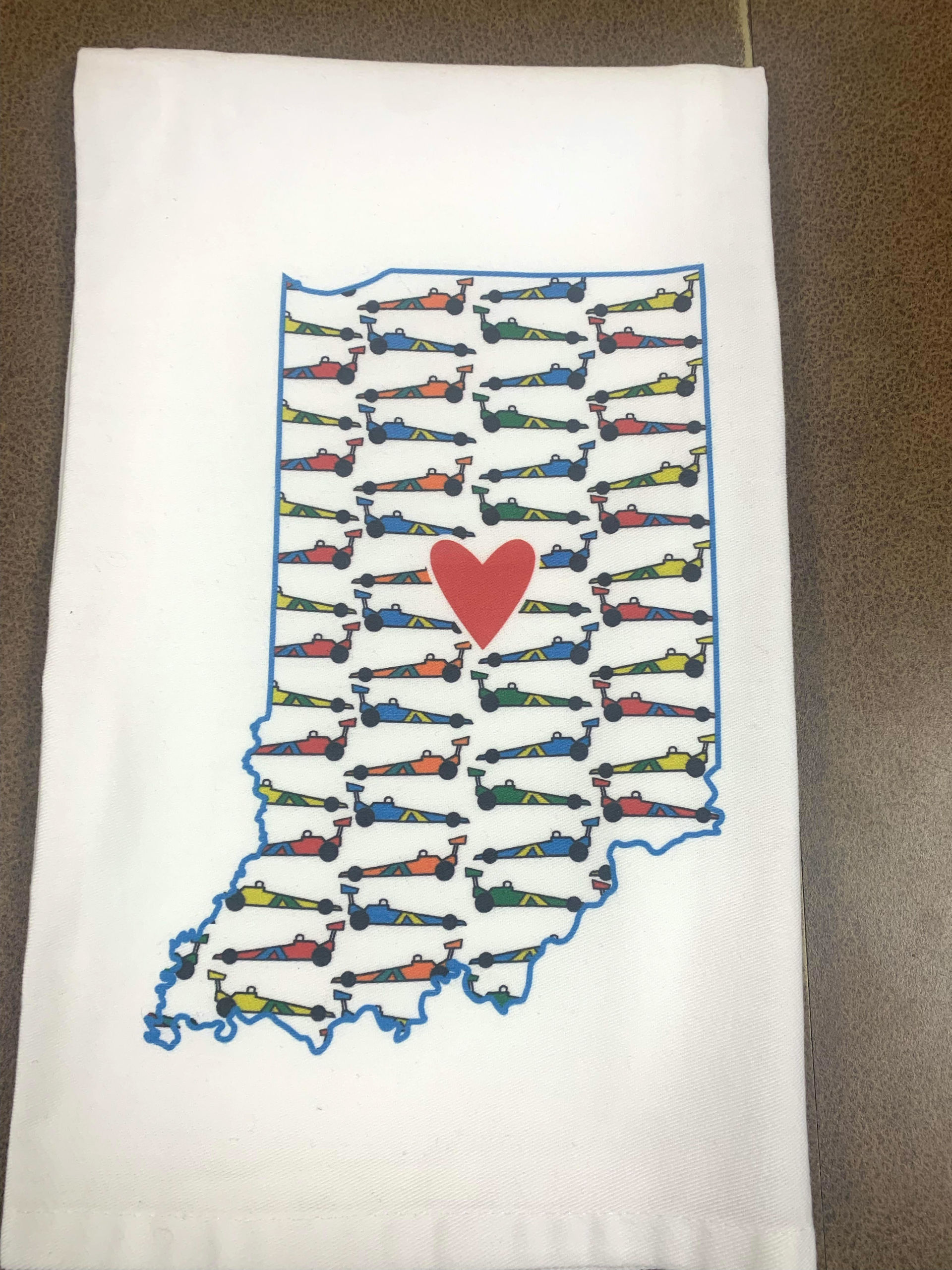 A dish towel printed with race cars