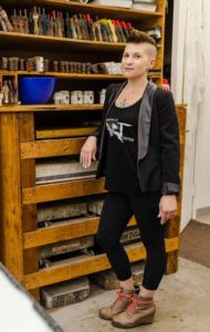 woman with short hair soft smiling in an art room