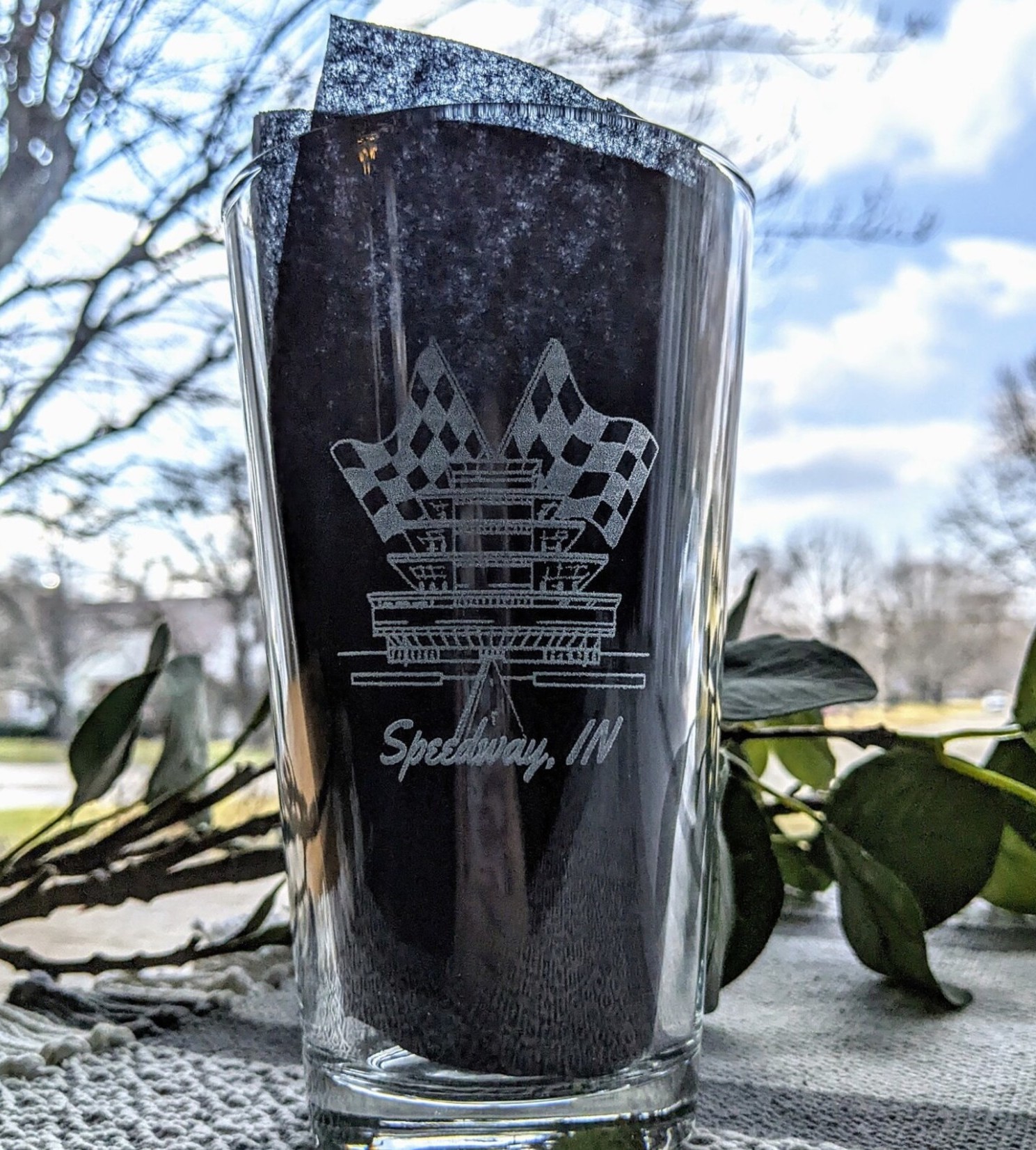A pint glass etched with the Indianapolis Motor Speedway pagoda