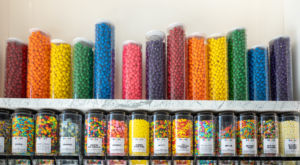 A photo of a candy wall with a rainbow of candy colors