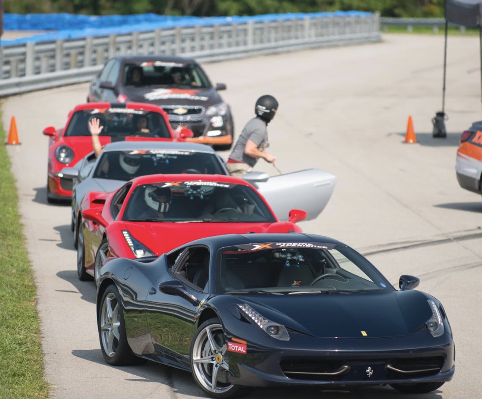 black and red race cars on lined up on a race track