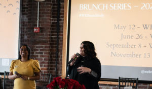 A photo of two women speaking at a women equity brunch event