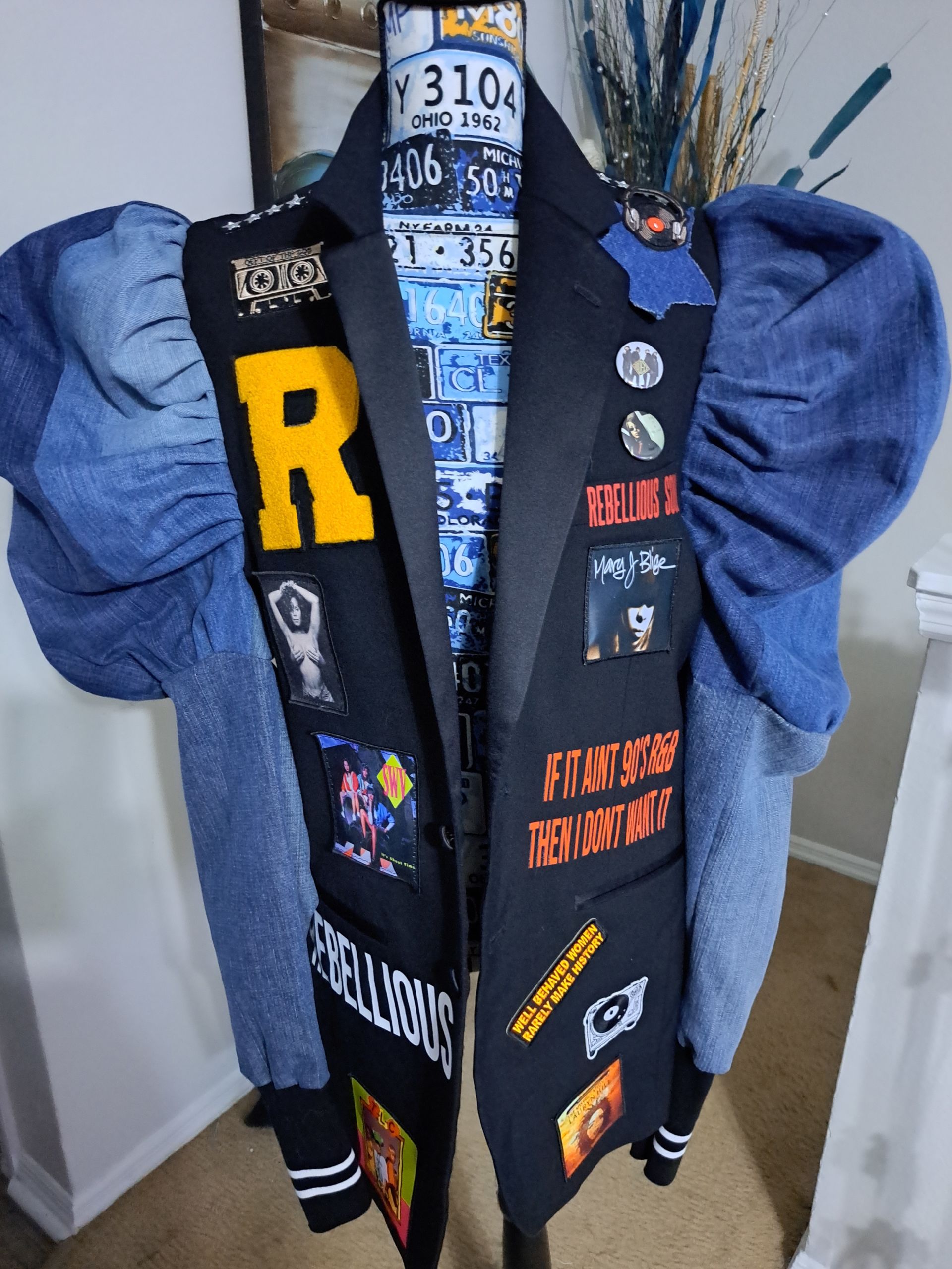 denim ruffled jacket with big yellow R letter patch and other colorful patches