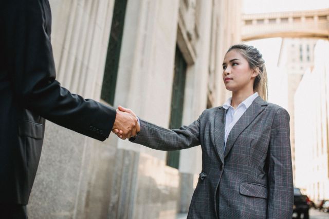 Woman shaking hands how to deal with difficult people