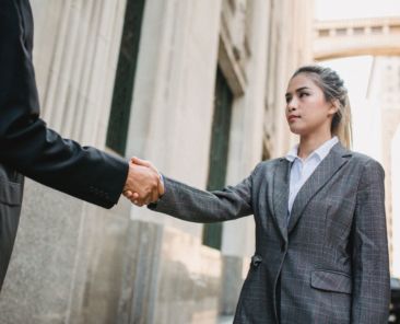 Woman shaking hands how to deal with difficult people