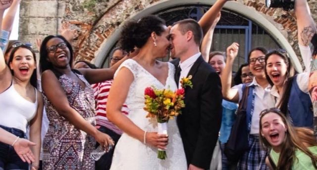 A man and woman kissing after getting married