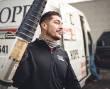 A Hope Plumbing employee walking outside