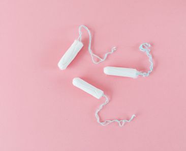 Three tampons on a pink background