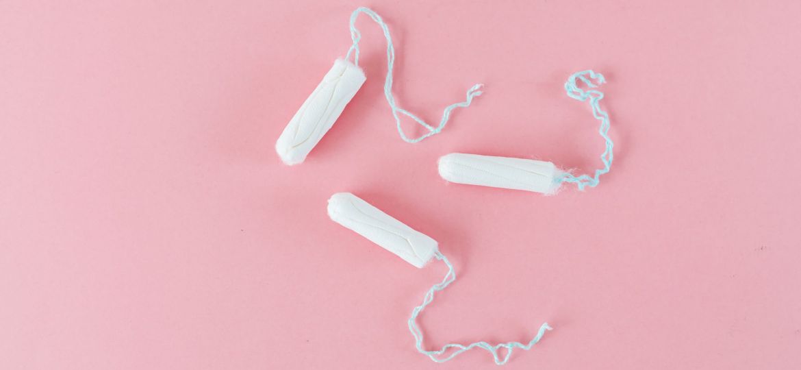 Three tampons on a pink background