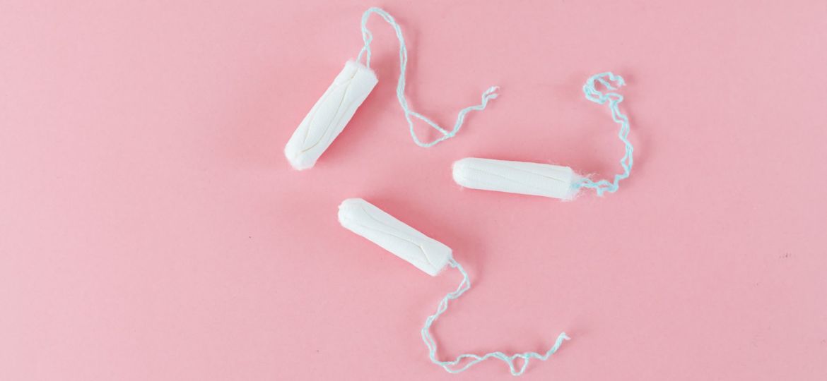 Three tampons on a pink background