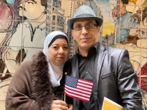 a photo of Waed and Fadi from Syria holding the American flag
