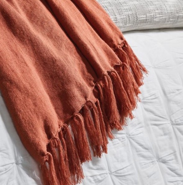 A rust colored throw blanket
