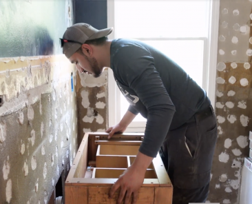 A plumber installing a sink