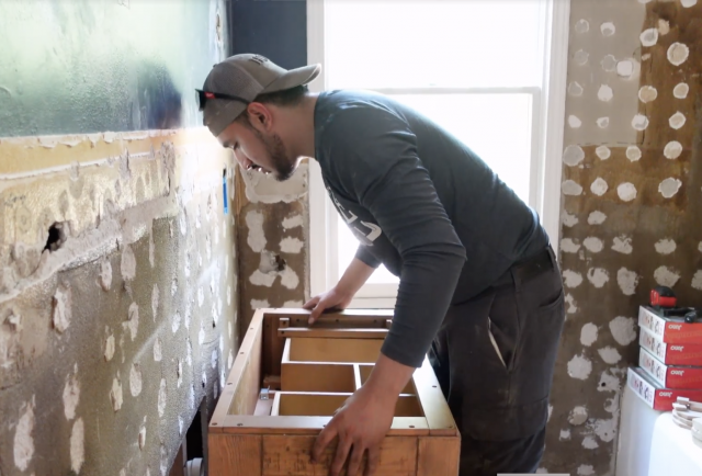 A plumber installing a sink