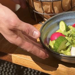 A person serving guacamole