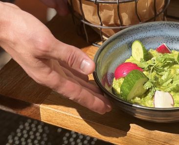 A person serving guacamole