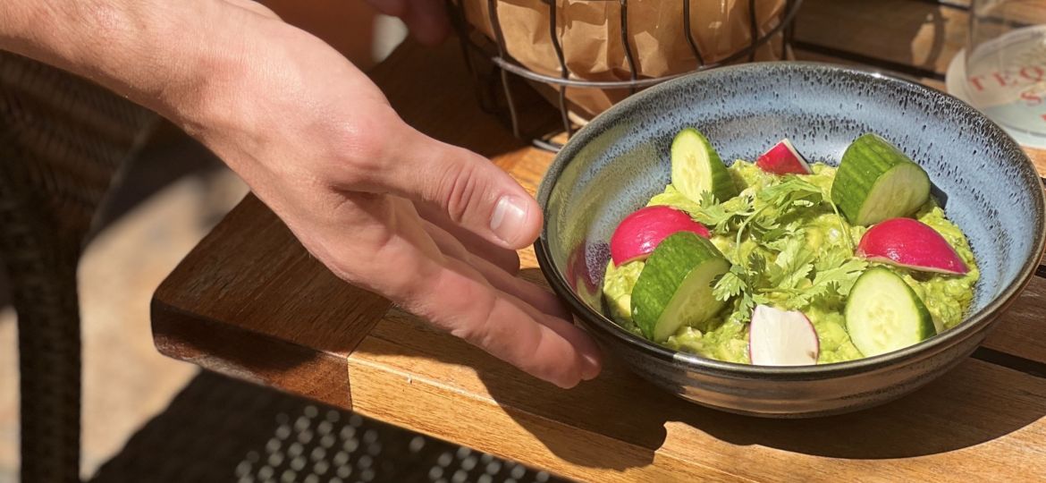 A person serving guacamole