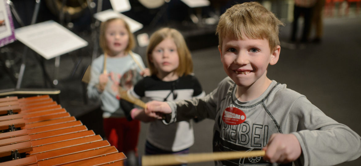 Children playing with percussion music instruments