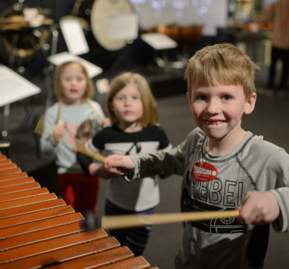 Children playing with percussion music instruments