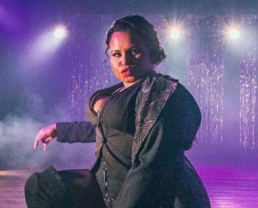 A photo of Dahlia "Daddy" Desire performing on stage