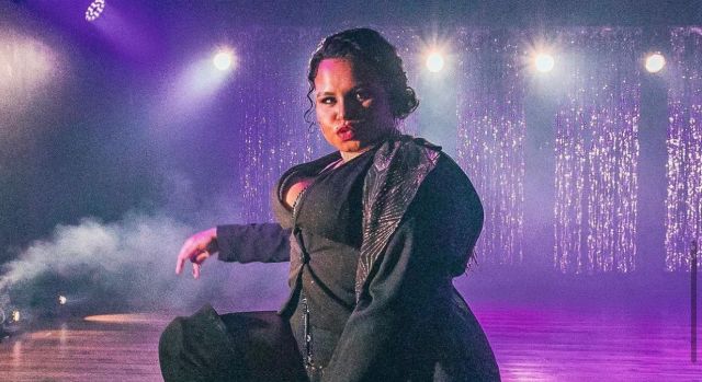 A photo of Dahlia "Daddy" Desire performing on stage