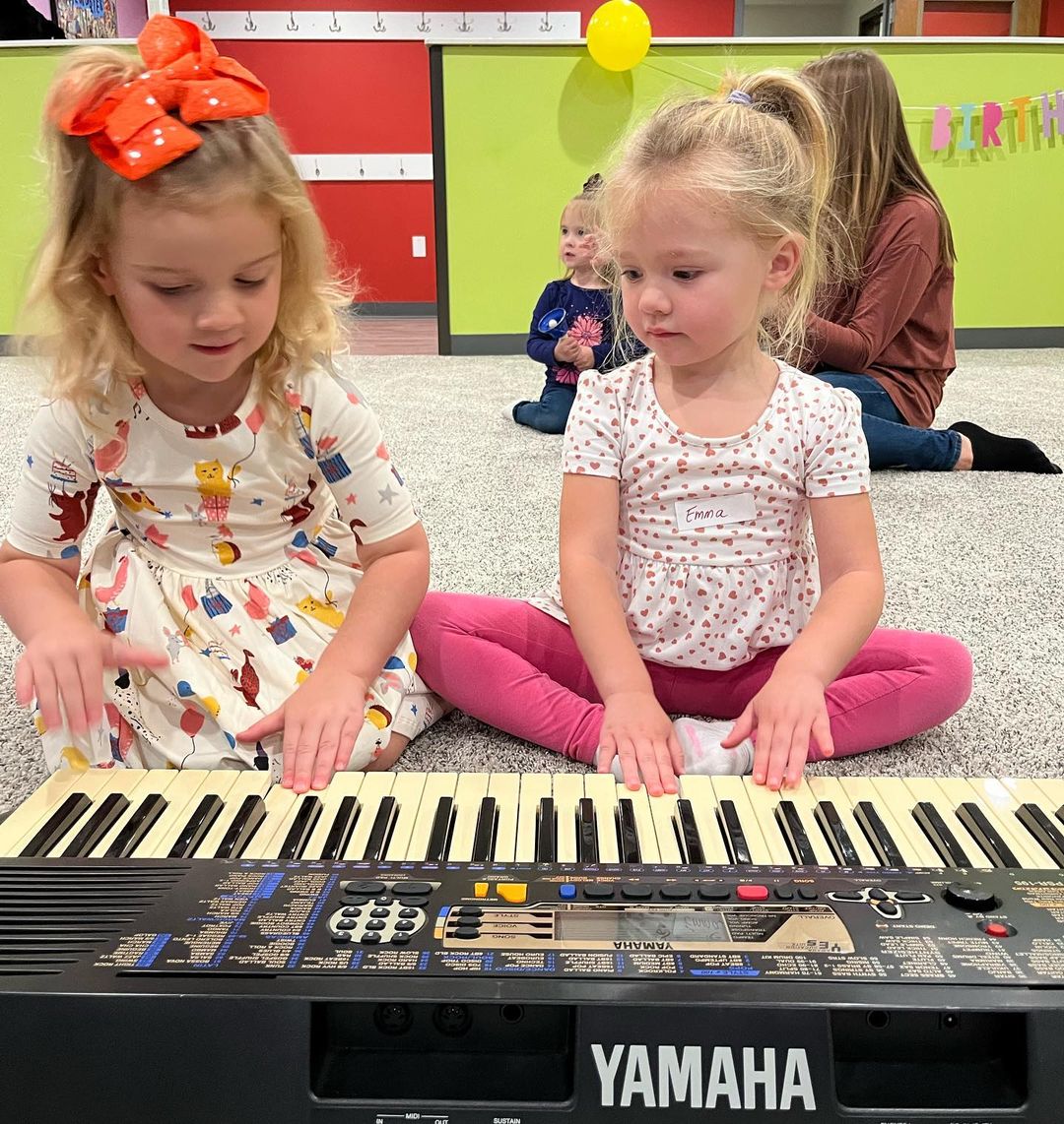 Two girls playing a keyboard at The Music Playhouse
