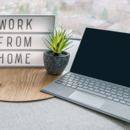 Desktop with a work from home sign signifying remote work