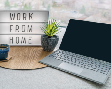 Desktop with a work from home sign signifying remote work