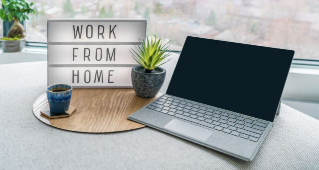 Desktop with a work from home sign signifying remote work