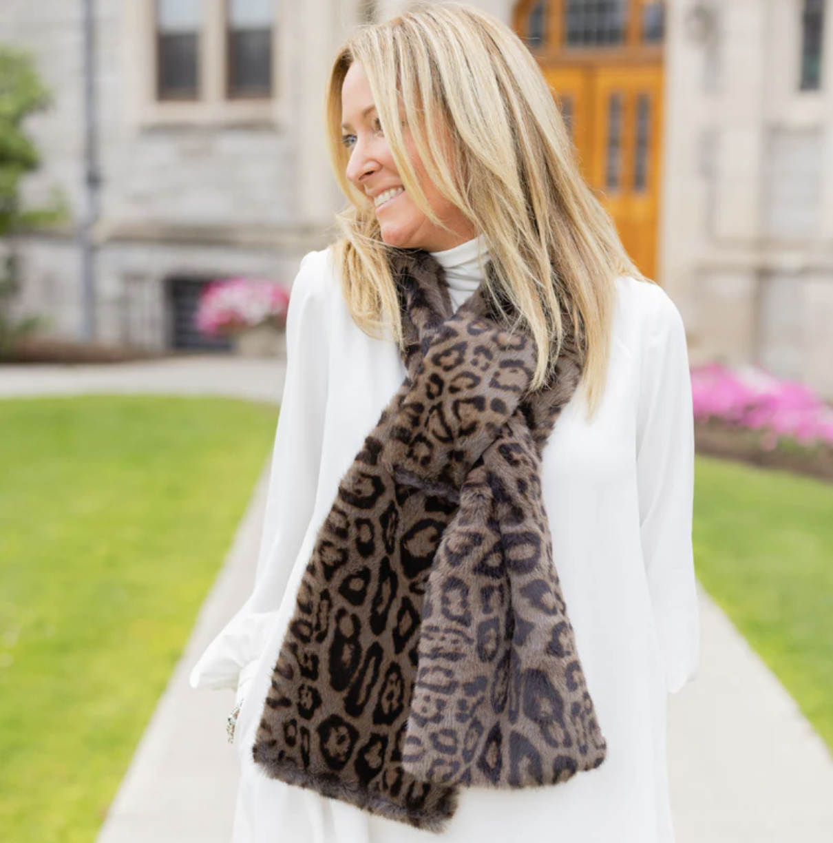A woman wearing a cozy animal print faux fur scarf
