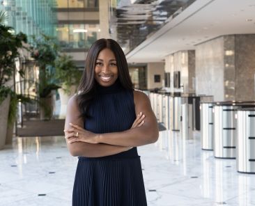 Portia Bailey-Bernard with her arms crossed and smiling