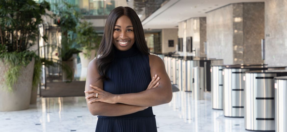 Portia Bailey-Bernard with her arms crossed and smiling