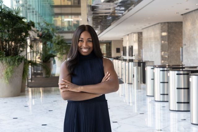 Portia Bailey-Bernard with her arms crossed and smiling