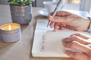 Hands Writing in a Gratitude Journal