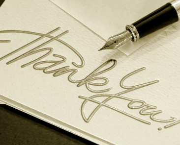 card reading "thank you" with a fountain pen resting on it