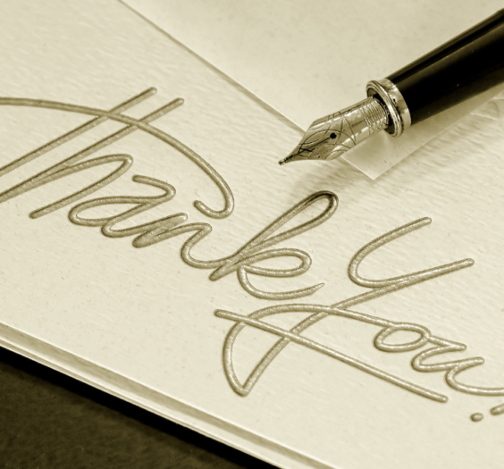 card reading "thank you" with a fountain pen resting on it