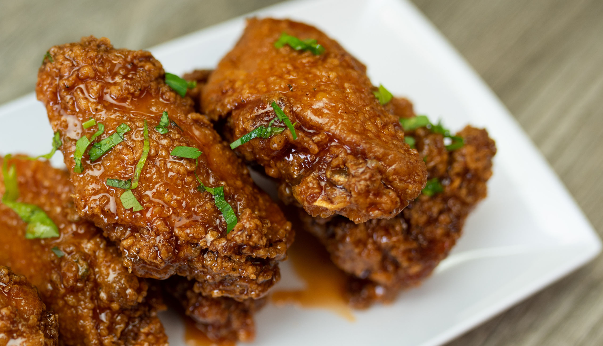 3 Mango Habanero Wings (1) Mango Habanero wings served on a white plate
