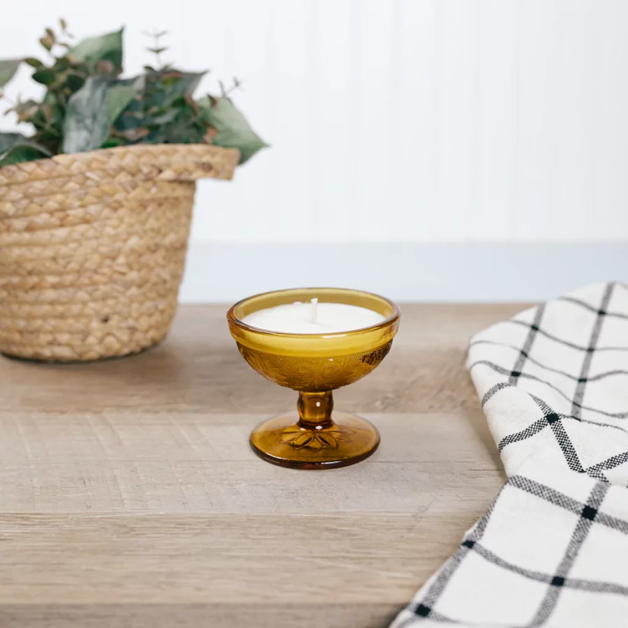 Candle in a goblet staged on a wooden table