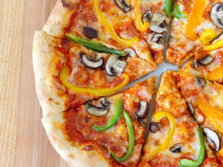 Cheese pizza with green and yellow peppers and mushrooms