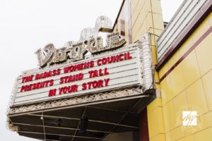Vogue theatre sign with red lettering that says"Badass Womens Council Presents Stand Tall in Your Story