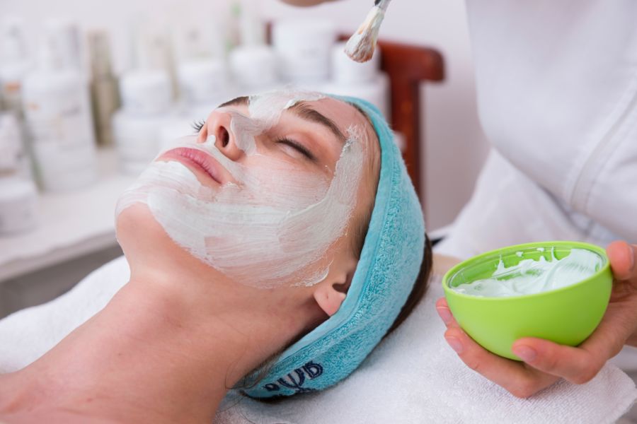 Woman laying down getting a facial