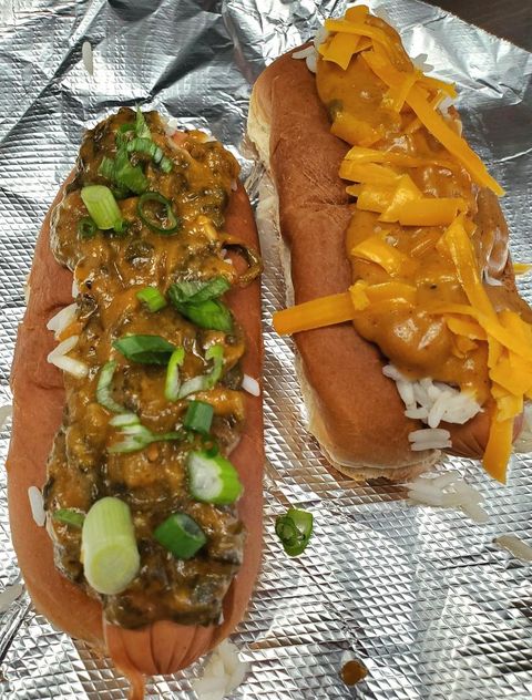 Two of GoldLeaf's specialty hot dogs with Yats étoufée