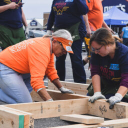 Volunteer Tiger Carol working with Women Build Volunteer to build a home