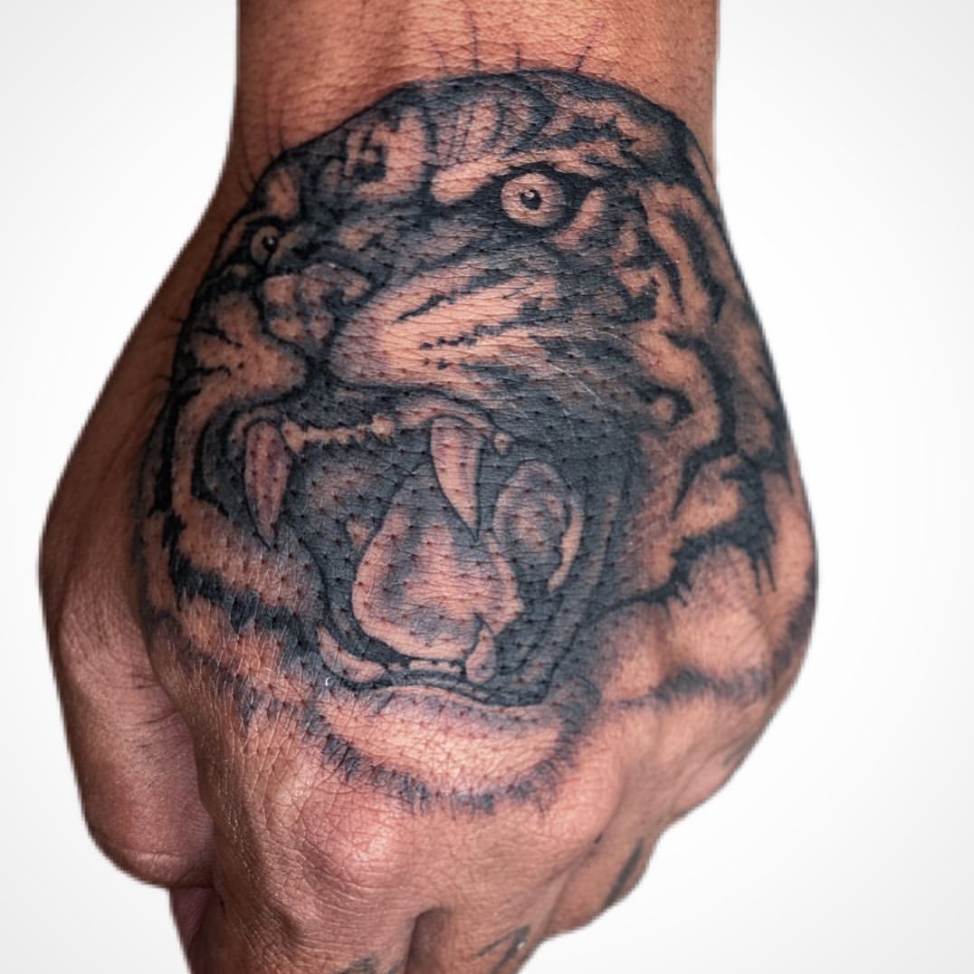 Tiger hand tattoo by Megan Zoeller