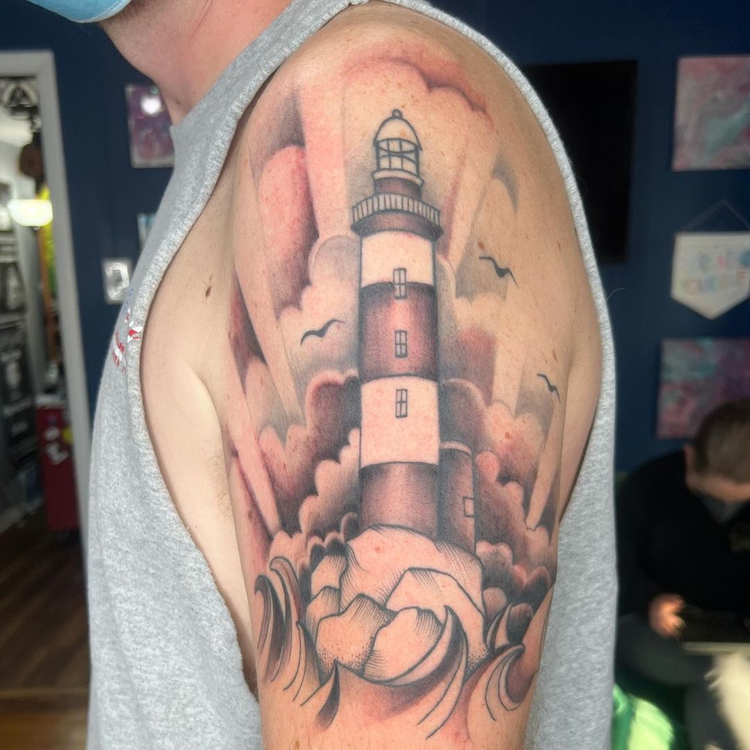 Shoulder tattoo of a light house