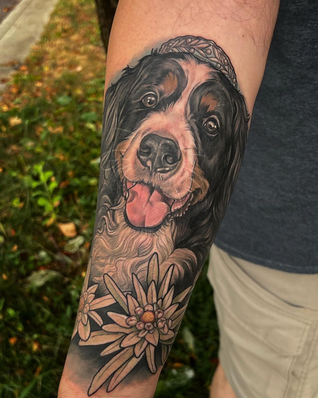 Arm tattoo of a dog