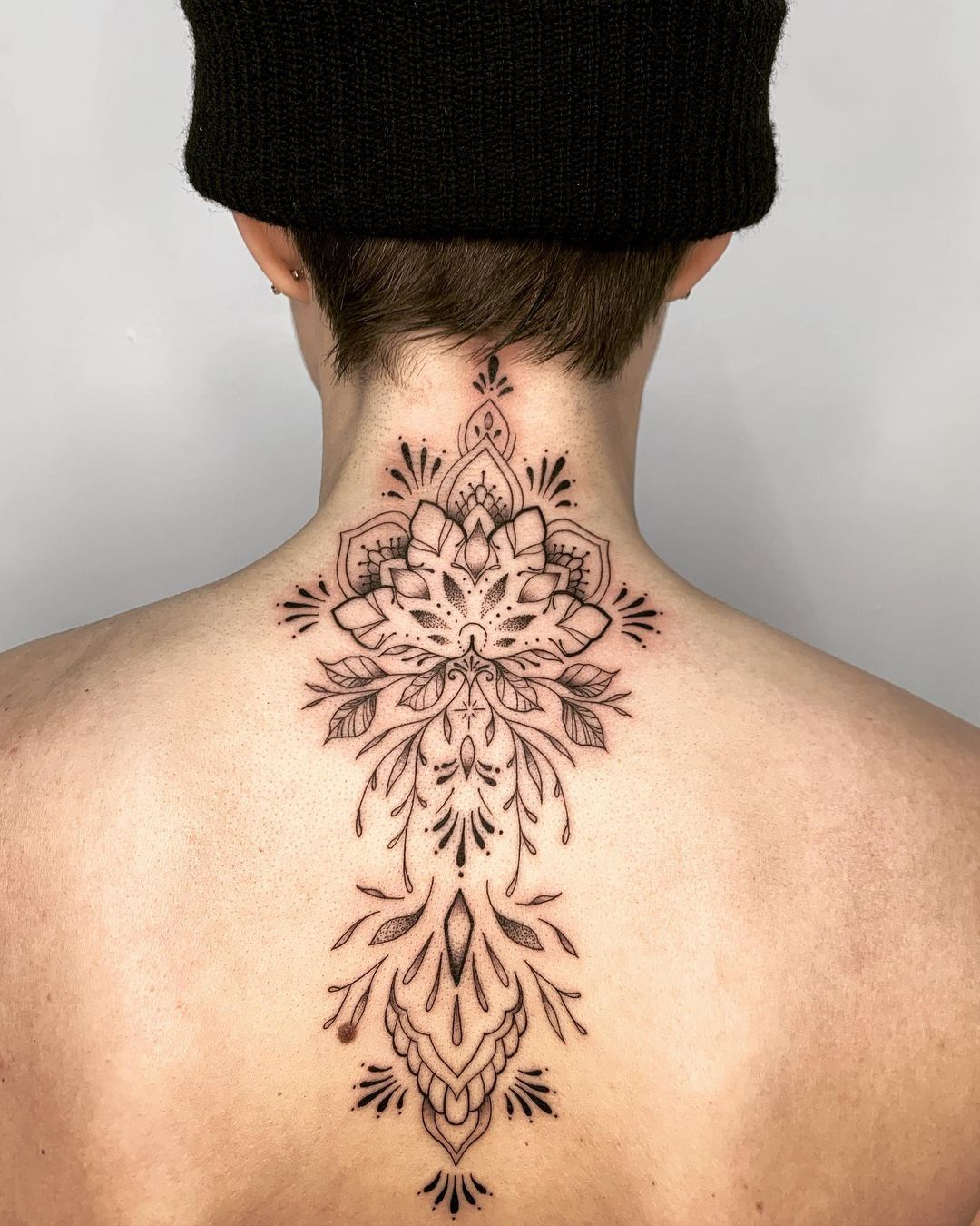 Upper spine flower tattoo by Lexie Hall