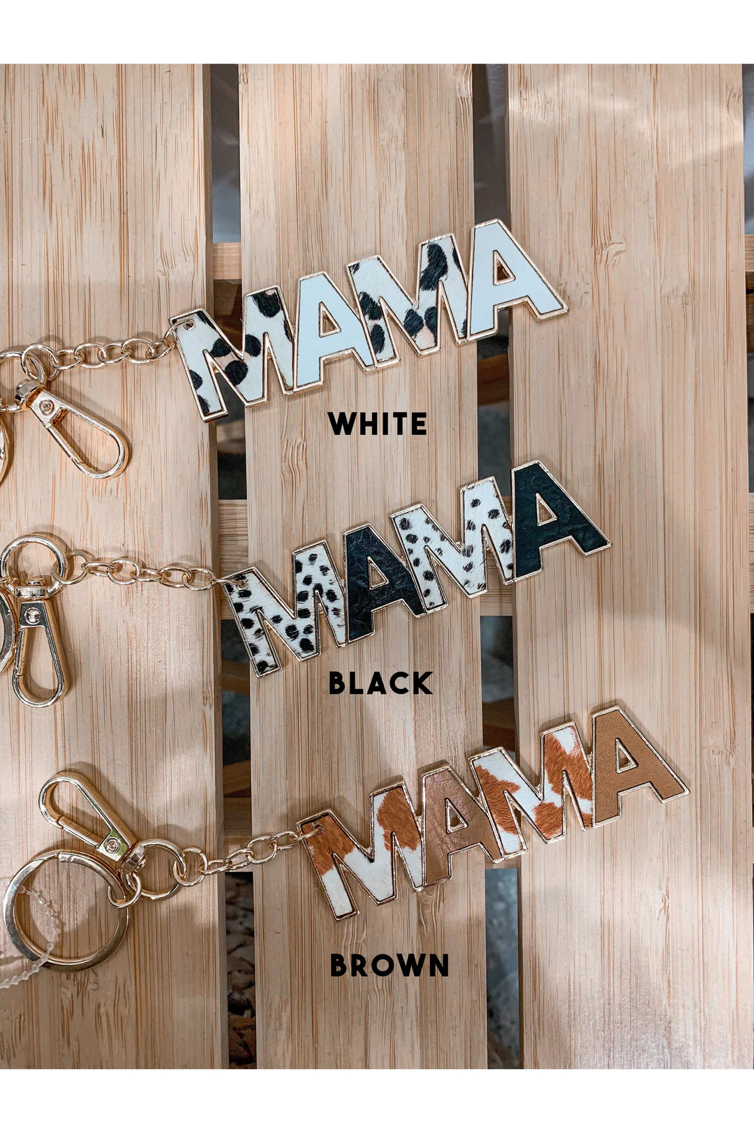 Three animal print keychains with the word "Mama" on them.